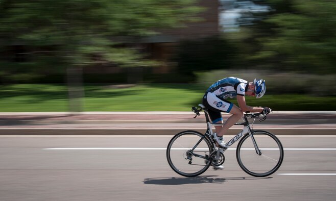 PETERSON AIR FORCE BASE, Colo. – A participant in the 21st Space Wing Sports & Field Day cycles at Peterson Air Force Base, Colorado, July 12, 2018. Airmen and civilians at Peterson AFB bike for exercise, recreation and commuting and are required to wear a helmet while operating human powered vehicles on the installation. (U.S. Air Force photo by 2nd Lt. Justin Davidson-Beebe)