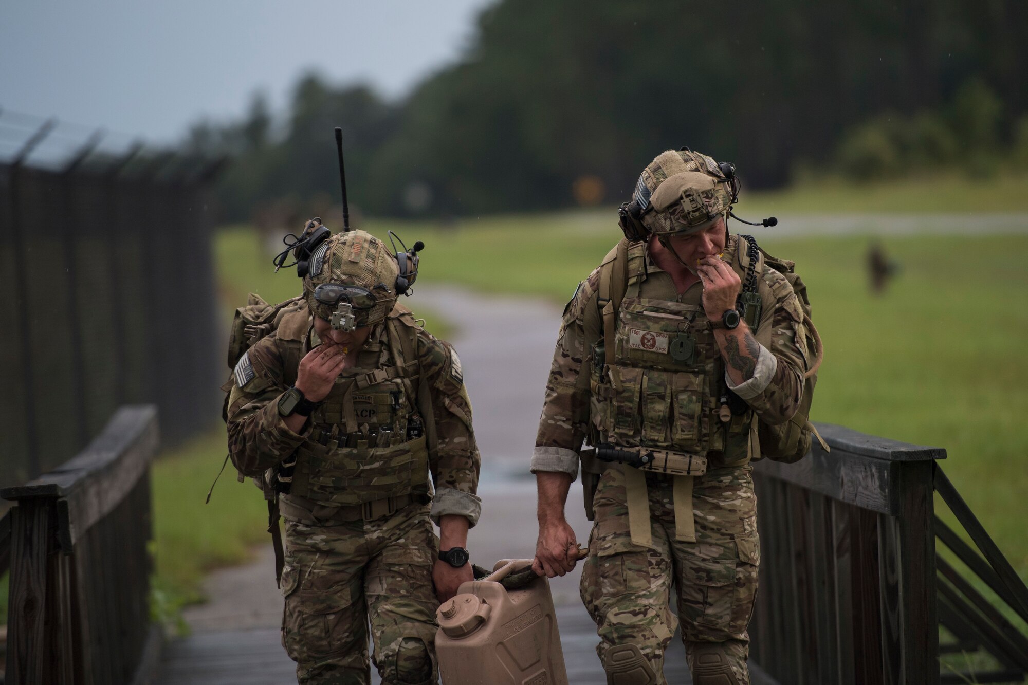 Staff Sgt. Ryan Holst, left, and Tech. Sgt. Ryan Shipman, both 19th Air Support Operations Squadron joint terminal attack controllers (JTAC), grab a quick bite while executing a ruck march during Draco Spear, Aug. 3, 2018, at Moody Air Force Base, Ga. Draco Spear is a revival of the mid-2000s joint-training event Dragon Challenge that tested the top JTACs from various air support operations squadrons both mentally and physically. (U.S. Air Force photo by Senior Airman Janiqua P. Robinson)
