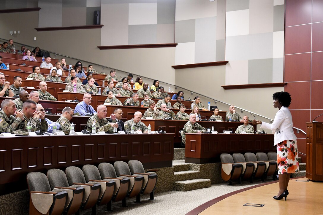 A woman talks about sexual assault prevention at a forum.