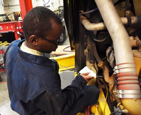 Airman 1st Class Victor Gathara, a 28th Logistics Readiness Squadron vehicle maintenance technician, checks an oil dipstick on a snow removal vehicle at Ellsworth Air Force Base, S.D., Aug. 9, 2018. Gathara and other members of the 28th LRS vehicle maintenance shop replace fluids and parts, when needed, on all of Ellsworth AFB’s snow fleet vehicles. (U.S. Air Force photo by Airman 1st Class Thomas Karol)