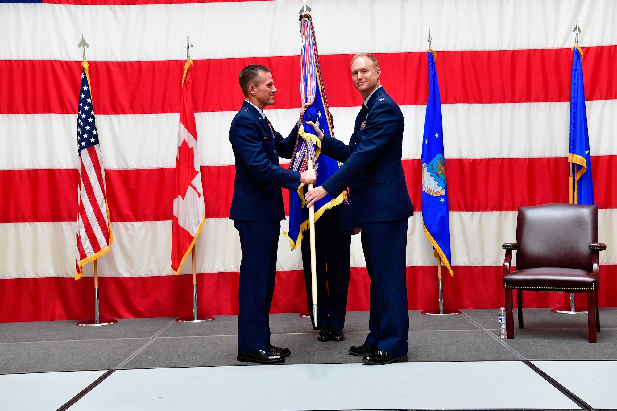 Col. Gregory Lewis (right) accepts command of the Western Air Defense Sector from the assumption of command presiding officer, Brig. Gen. Kenneth Ekman, First Air Force and Air Forces Northern Command vice commander, at the Washington Army National Guard Readiness Center, Joint Base Lewis-McChord, July 31, 2018.