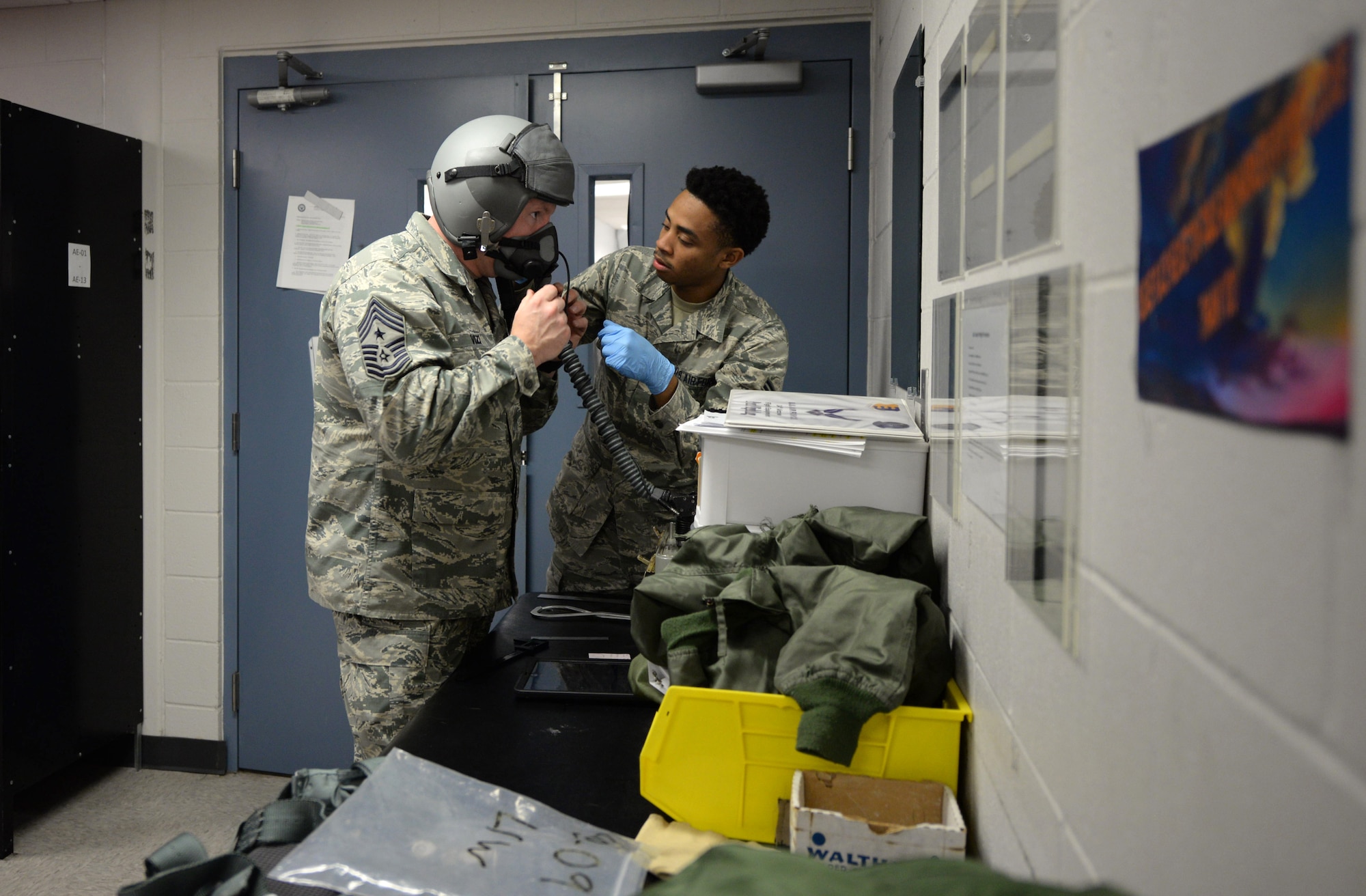 Airman 1st Class Trevor Garrett, a 28th Operations Support Squadron aircrew flight equipment technician, right, fits a gas mask for Chief Master Sgt. Adam Vizi, the 28th Bomb Wing command chief, at Ellsworth Air Force Base, S.D., March 14, 2017. AFE technicians perform a fit test for aircrew to ensure the mask is secure and won’t have any air leaks. (U.S. Air Force photo by Senior Airman Denise Jenson)