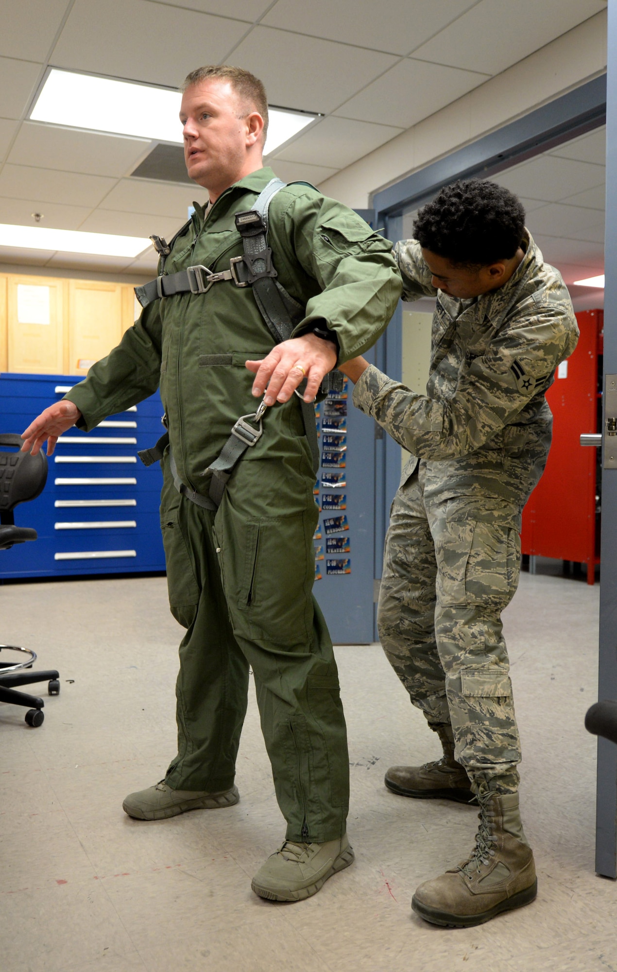 Airman 1st Class Trevor Garrett, a 28th Operations Support Squadron aircrew flight equipment technician, right, fits a flight suit for Chief Master Sgt. Adam Vizi, the 28th Bomb Wing command chief, at Ellsworth Air Force Base, S.D., March 14, 2017. AFE technicians are tasked with performing thorough inspections on equipment such as aircrew helmets, oxygen masks and harnesses, as well as making any necessary repairs. (U.S. Air Force photo by Senior Airman Denise Jenson)