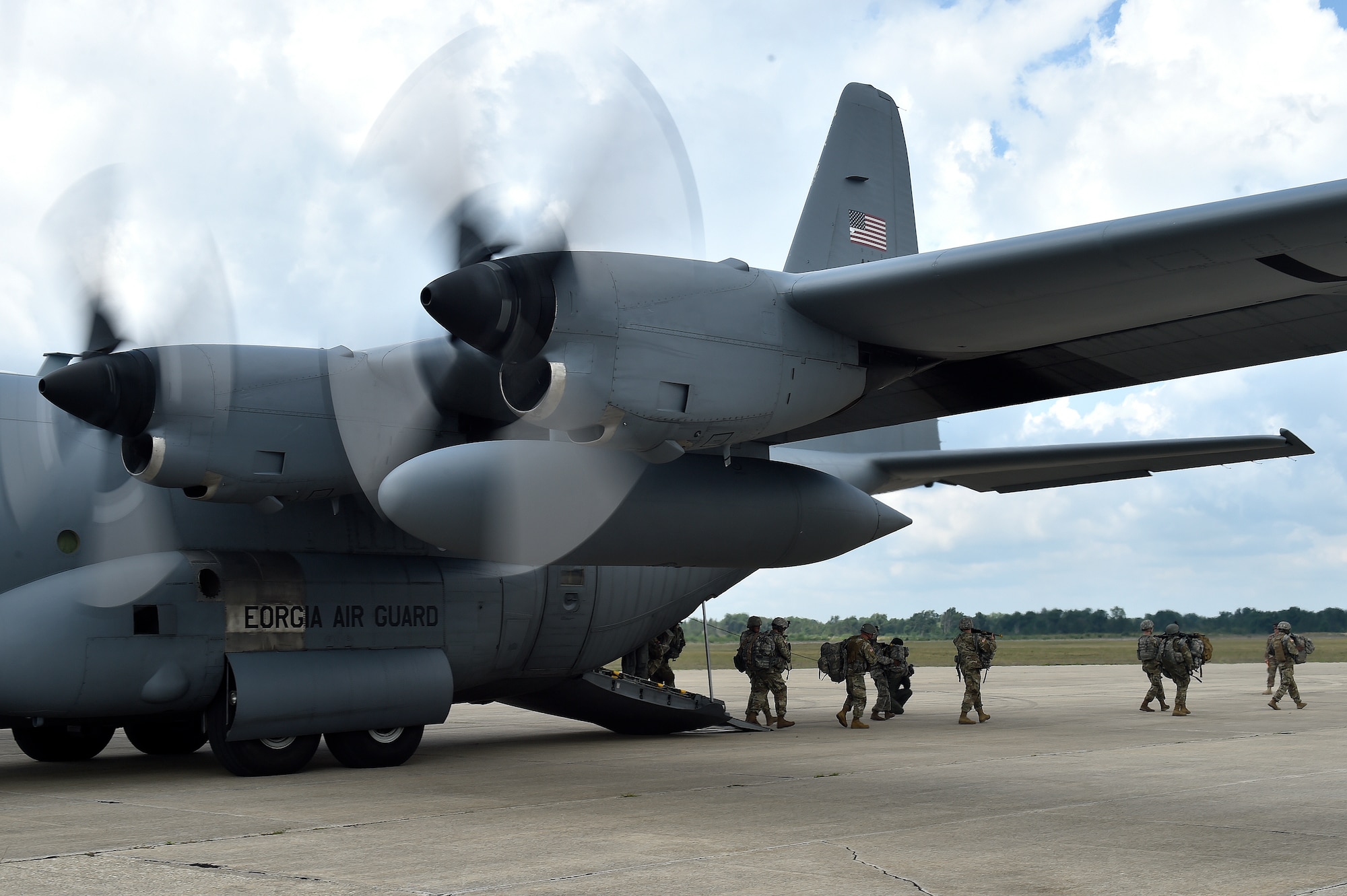 Soldiers assigned to the Massachusetts National Guard, 3-126th Aviation Battalion, deplane from a C-130H Hercules aircraft, during exercise Northern Strike at Grayling Army Airfield, Mich., Aug. 8. Northern Strike is a robust military readiness exercise coordinated by the Michigan Army National Guard which features joint and multi-national militaries working together for total force integration. (U.S. Air Force photo by Tech. Sgt. Liliana Moreno)