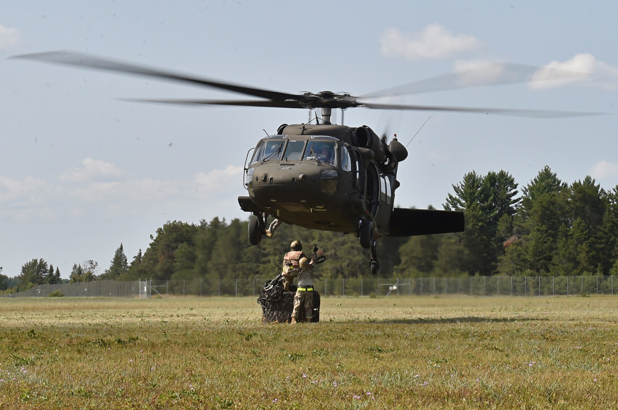 Contingency Response Airmen assigned to the 621st Contingency Response Wing from Travis Air Force Base, Calif., secure a cargo load to a UH-60 Blackhawk helicopter during exercise Northern Strike at Alpena Combat Readiness Training Center, Mich., Aug. 8. Northern Strike is a robust military readiness exercise coordinated by the Michigan Army National Guard which features joint and multi-national militaries working together for total force integration. (U.S. Air Force photo by Tech. Sgt. Liliana Moreno)