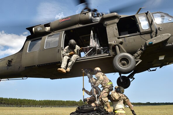 Contingency Response Airmen assigned to the 621st Contingency Response Wing from Travis Air Force Base, Calif., secure a cargo load to a UH-60 Blackhawk helicopter during exercise Northern Strike at Alpena Combat Readiness Training Center, Mich., Aug. 8. Northern Strike is a robust military readiness exercise coordinated by the Michigan Army National Guard which features joint and multi-national militaries working together for total force integration. (U.S. Air Force photo by Tech. Sgt. Liliana Moreno)