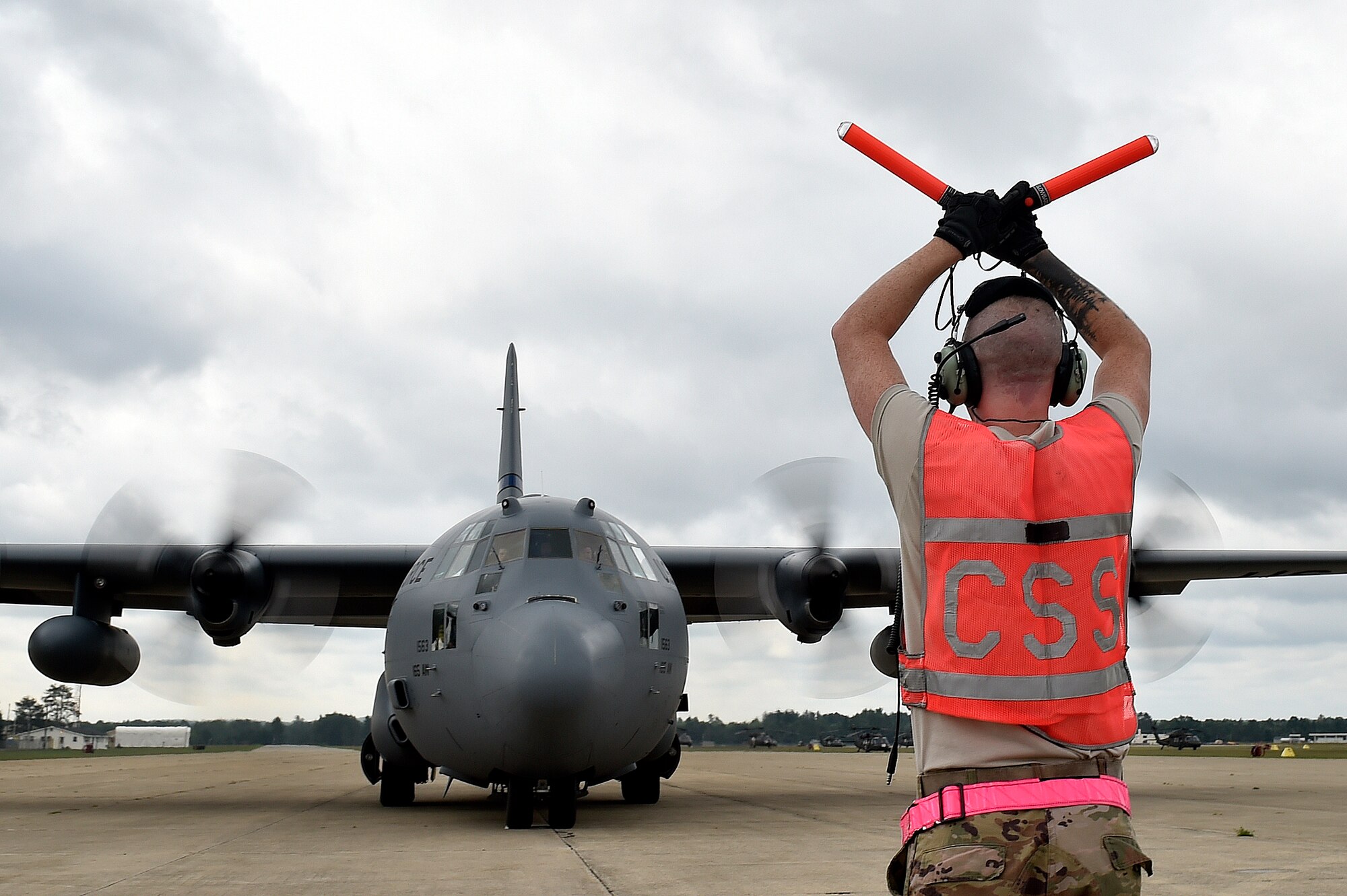 Staff Sgt. Benjamin Stover, 821st Contingency Response Support Squadron crew chief, marshals a C-130H Hercules aircraft, during exercise Northern Strike at Grayling Army Airfield, Mich., Aug. 9. Northern Strike is a robust military readiness exercise coordinated by the Michigan Army National Guard which features joint and multi-national militaries working together for total force integration. (U.S. Air Force photo by Tech. Sgt. Liliana Moreno)