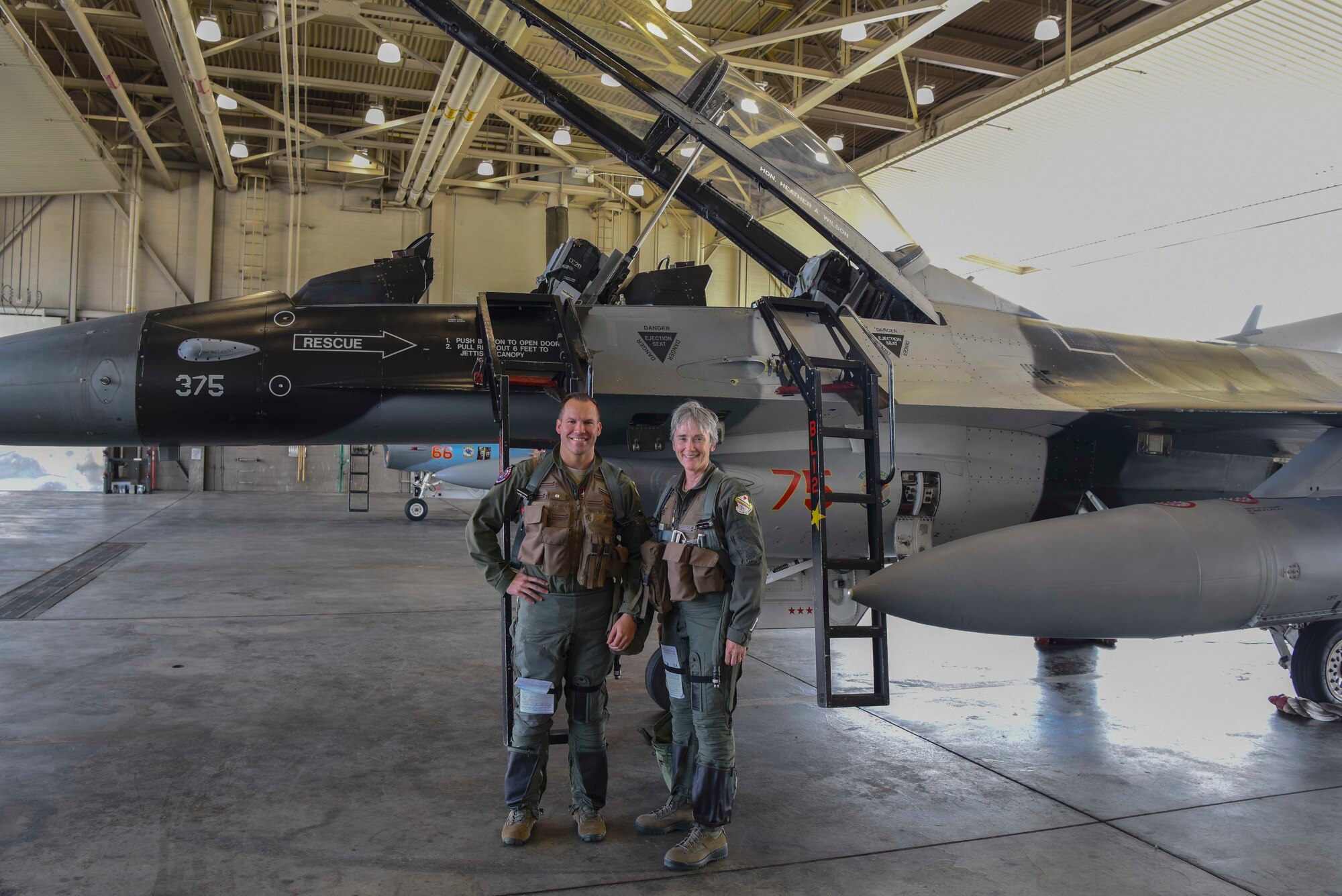 The Honorable Heather A. Wilson, the Secretary of the Air Force, poses for a photo with Lt. Col. John Anderson, the 353rd Combat Training Squadron commander, Aug. 10, 2018 at Eielson Air Force Base, Alaska. Wilson and Anderson later flew in the F-16D Fighting Falcon over part of the Joint Pacific Alaska Range Complex. (U.S. Air Force photo by Airman 1st Class Eric M. Fisher)