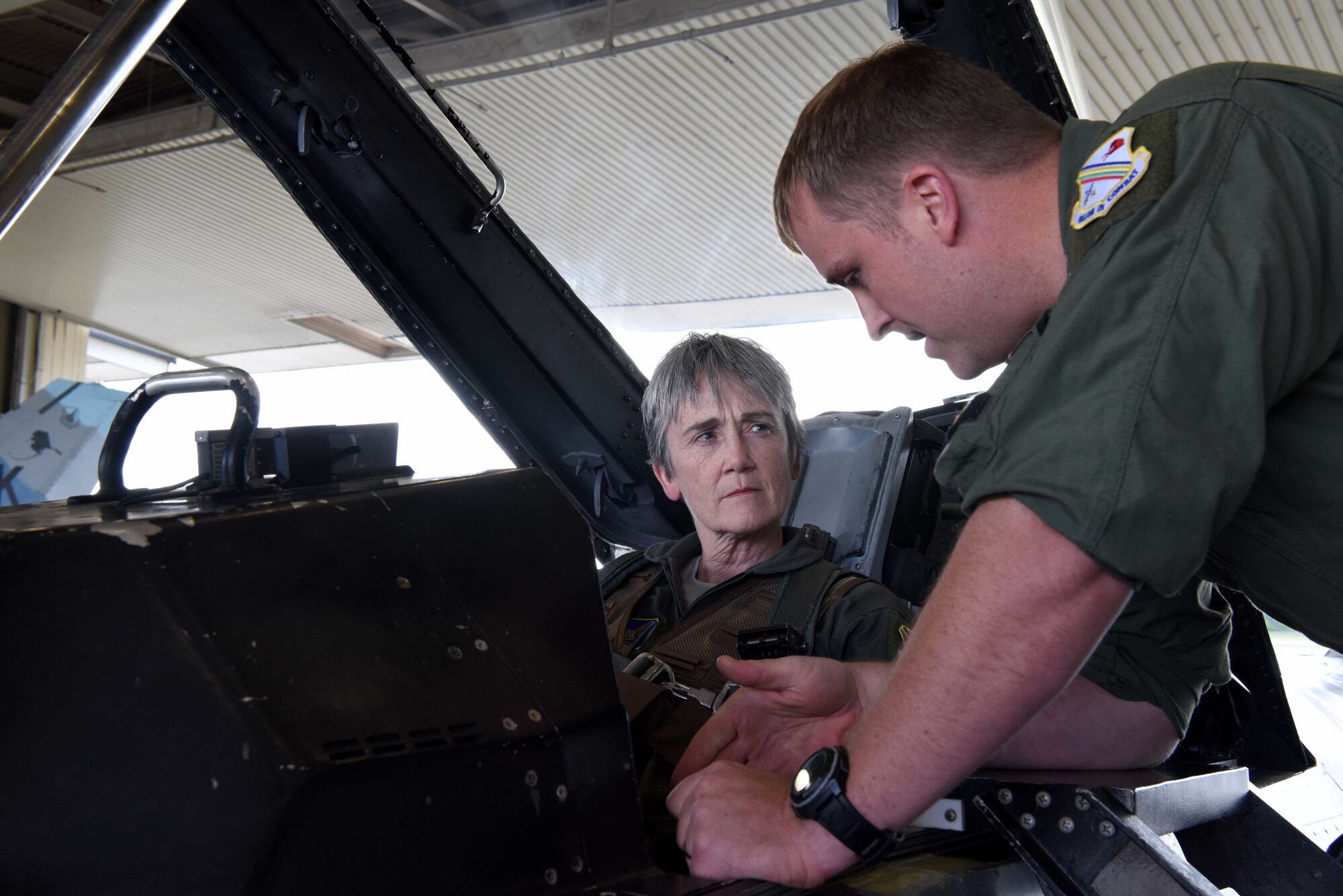 A 354th Fighter Wing Airman briefs the Honorable Heather A. Wilson, the Secretary of the Air Force, before her flight Aug. 10, 2018, at Eielson Air Force Base, Alaska. The brief teaches passengers the emergency procedures for the F-16D Fighting Falcon. (U.S. Air Force photo by Airman 1st Class Eric M. Fisher)
