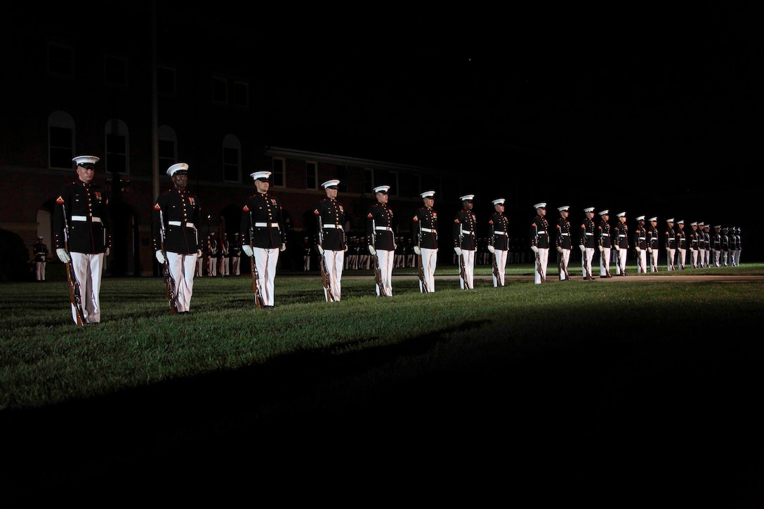 U.S. Marines with the Silent Drill Platoon perform during an evening parade at Marine Barracks Washington, D.C., Aug. 10, 2018. Richard V. Spencer, Secretary of the Navy, was the honored guest at this evening’s parade.