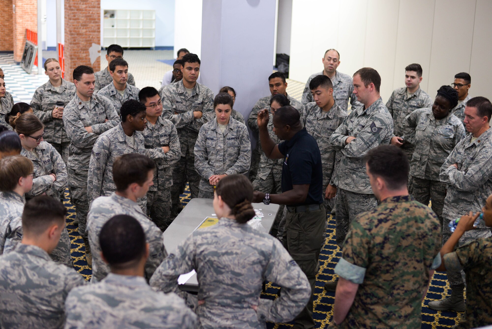 Mr. Laukton Rimpel, MCBC Instructor, demonstrates how to use tabletop simulations for real-world results at Yokota Air Base, Japan, August 8, 2018.