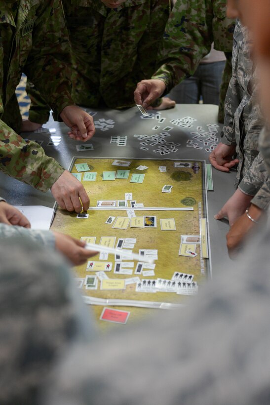 United States and Japanese military members work together during a tabletop simulation at Yokota Air Base, Japan, August 8, 2018.