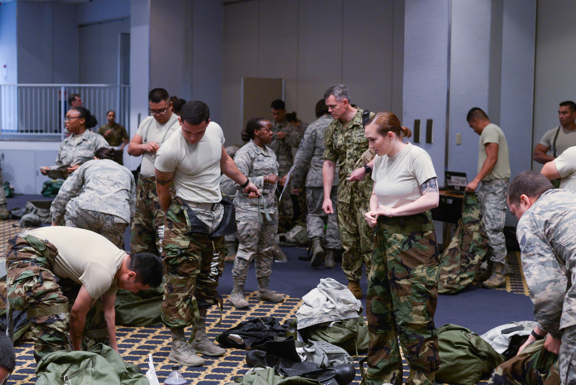 Members from the medical field prepare for practical training by getting into MOPP 2 gear at Yokota Air Base, Japan, August 8, 2018.