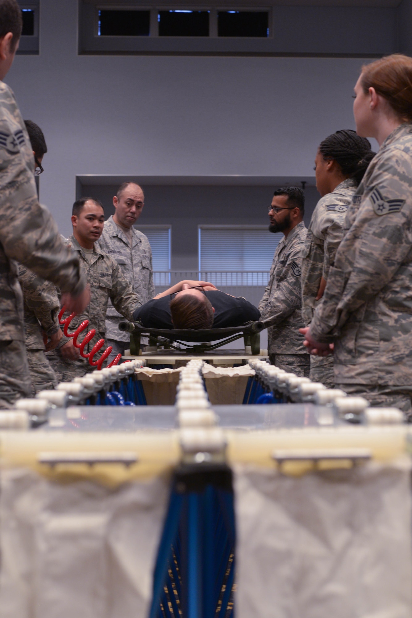 Mr. Laukton Rimpel, MCBC Instructor, demonstrates the usefulness of the personal first aid kit included with MOPP gear at Yokota Air Base, Japan, August 8, 2018