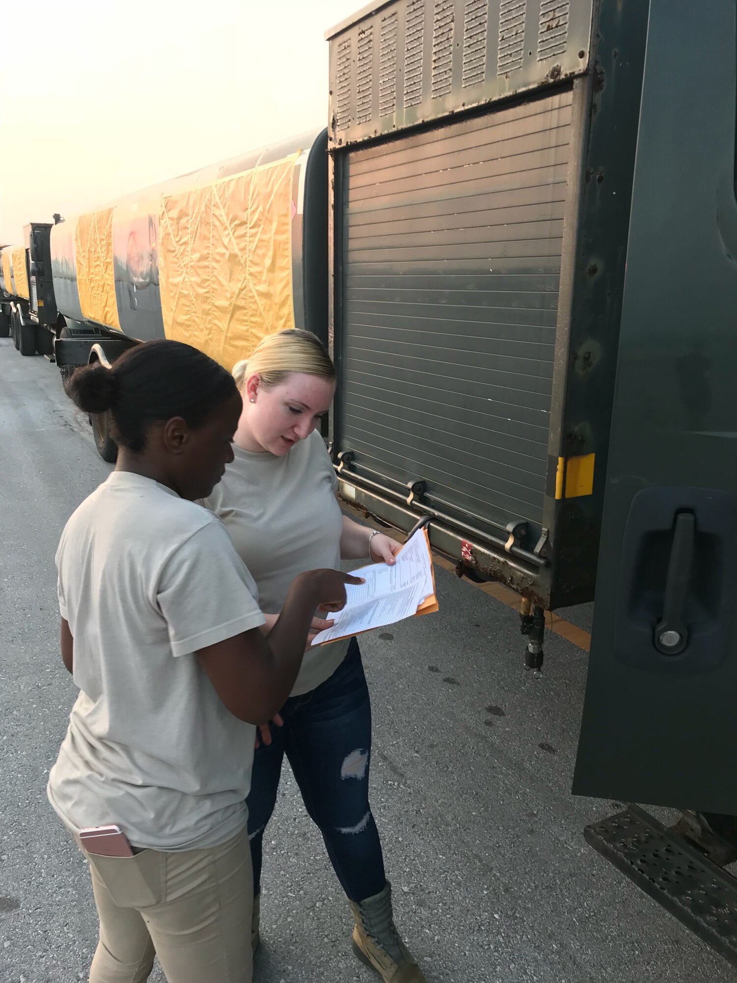(On left) On 9 Aug., 927th Traffic Management Office technicians, Airman 1st Class Saqueta James and Airman 1st Class Zoe Ridge, ensured the paperwork was in order for a shipment of R-11 Refueler trucks were correctly marked for shipping from Aja Port, Japan. 

 

Citizen Airmen from the 927th Logistics Readiness Squadron, MacDill Air Force Base, Florida, traveled to Kadena Air Base, Japan to perform their two-week annual training and work alongside their active duty counterparts from the 18th LRS. (U.S. Air Force photo by Master Sgt. Thomas Berger)