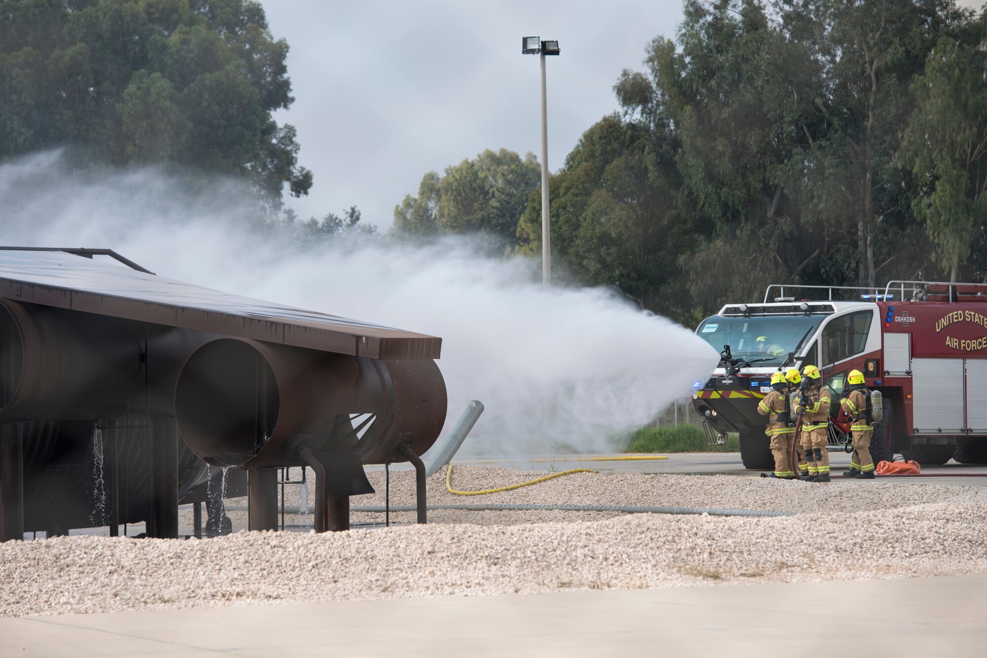 A fire truck puts out a simulated aircraft fire at Incirlik Air Base, Turkey, Aug. 7, 2018