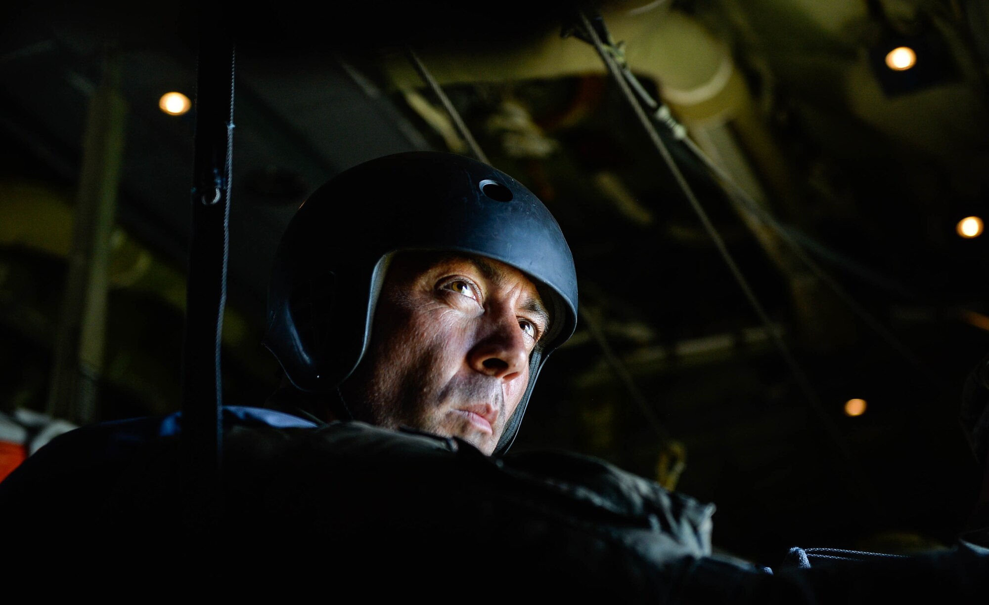 A Polish military parachute instructor prepares to drop his paratroopers from a U.S. Air Force C-130J Super Hercules over Poland Aug. 7, 2018. U.S. Airmen assigned to the 86th Airlift Wing and U.S. Soldiers assigned to the 5th Quartermaster worked with their Polish partners to airdrop paratroopers during the annual Aviation Rotation bilateral exercise. (U.S. Air Force photo by Senior Airman Joshua Magbanua)