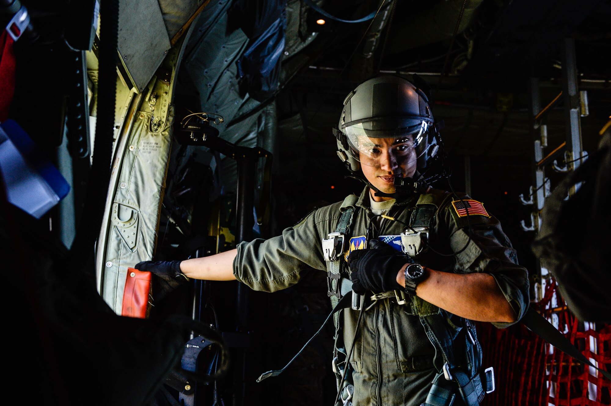 U.S. Air Force Airman 1st Class Alexander J Loberg, 37th Airlift Squadron C-130J Super Hercules loadmaster, stands by the side door of his aircraft as he assists with airdrop operations over Poland, Aug. 7, 2018. U.S. aircrews and aircraft airdropped Polish paratroopers as part of Aviation Rotation 18-4, a bilateral exercise between the U.S. and Polish armed forces. (U.S. Air Force photo by Senior Airman Joshua Magbanua)