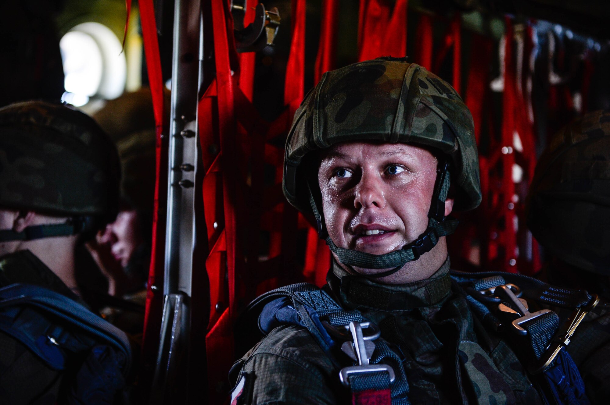 A Polish paratrooper sits down after boarding a U.S. Air Force C-130J Super Hercules at Krakow, Poland, Aug. 7, 2018. Approximately 100 Polish paratroopers jumped from two U.S. aircraft during Aviation Rotation 18-4, an annual bilateral exercise between the U.S. and Polish militaries. (U.S. Air Force photo by Senior Airman Joshua Magbanua)