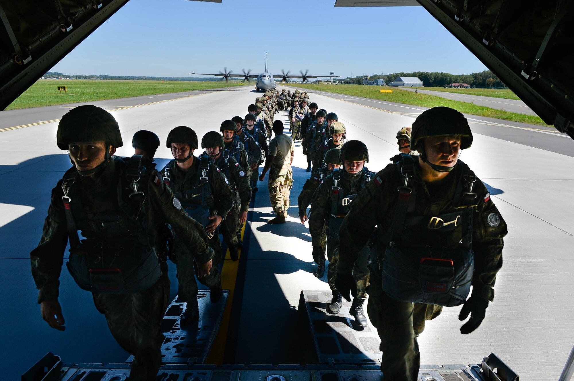 Polish paratroopers sit down after boarding a U.S. Air Force C-130J Super Hercules during Exercise Aviation Rotation 18-4 at Krakow, Poland, Aug. 7, 2018. The airdrop operations conducted during Aviation Rotation were static line jumps and High Altitude-Low Opening jumps. (U.S. Air Force photo by Senior Airman Joshua Magbanua)