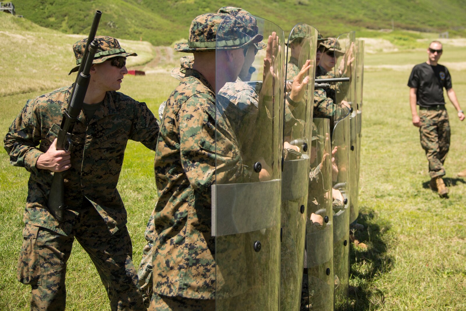 U.S. Marine Corps Pfc. Brody McCoy, an assaultman with Echo Company, 2nd Battalion, 3d Marine Regiment, conducts riot shield training during a non- lethal weapons fire familiarization and demonstration