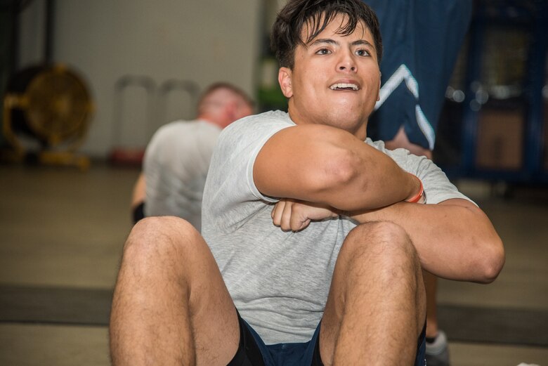 Senior Airman Kevin Kohan, an 11th Civil Engineer Squadron Explosive Ordnance Disposal journeyman at Joint Base Andrews, Md., performs the Extended Cross Knee Crunch Metronome of the EOD Tier 2 Physical Fitness Test Prototype at Dover Air Force Base, Del., Aug. 8, 2018. Kohan was one of more than 20 Airmen to participate in the EOD Tier 2 test prototype development. (U.S. Air Force photo by Staff Sgt. Damien Taylor)