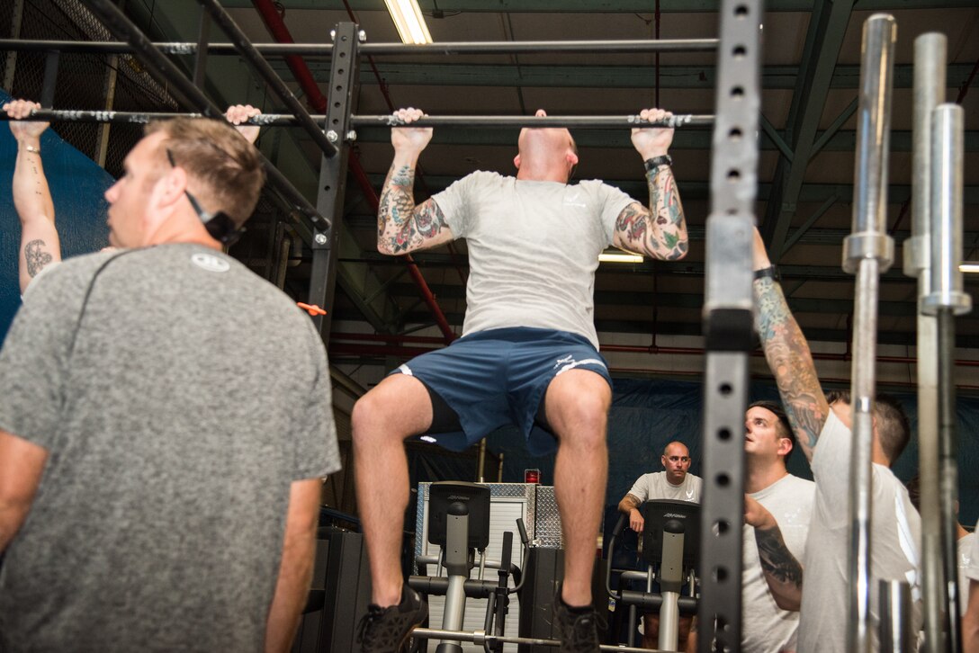 Explosive Ordnance Disposal Airmen perform the Pull-up component of the EOD Tier 2 Physical Fitness Test Prototype at Dover Air Force Base, Del., Aug. 8, 2018. EOD Airmen perform the Pull-up component of the test as a way to measure muscular endurance to complete EOD critical physical tasks. (U.S. Air Force photo by Staff Sgt. Damien Taylor)
