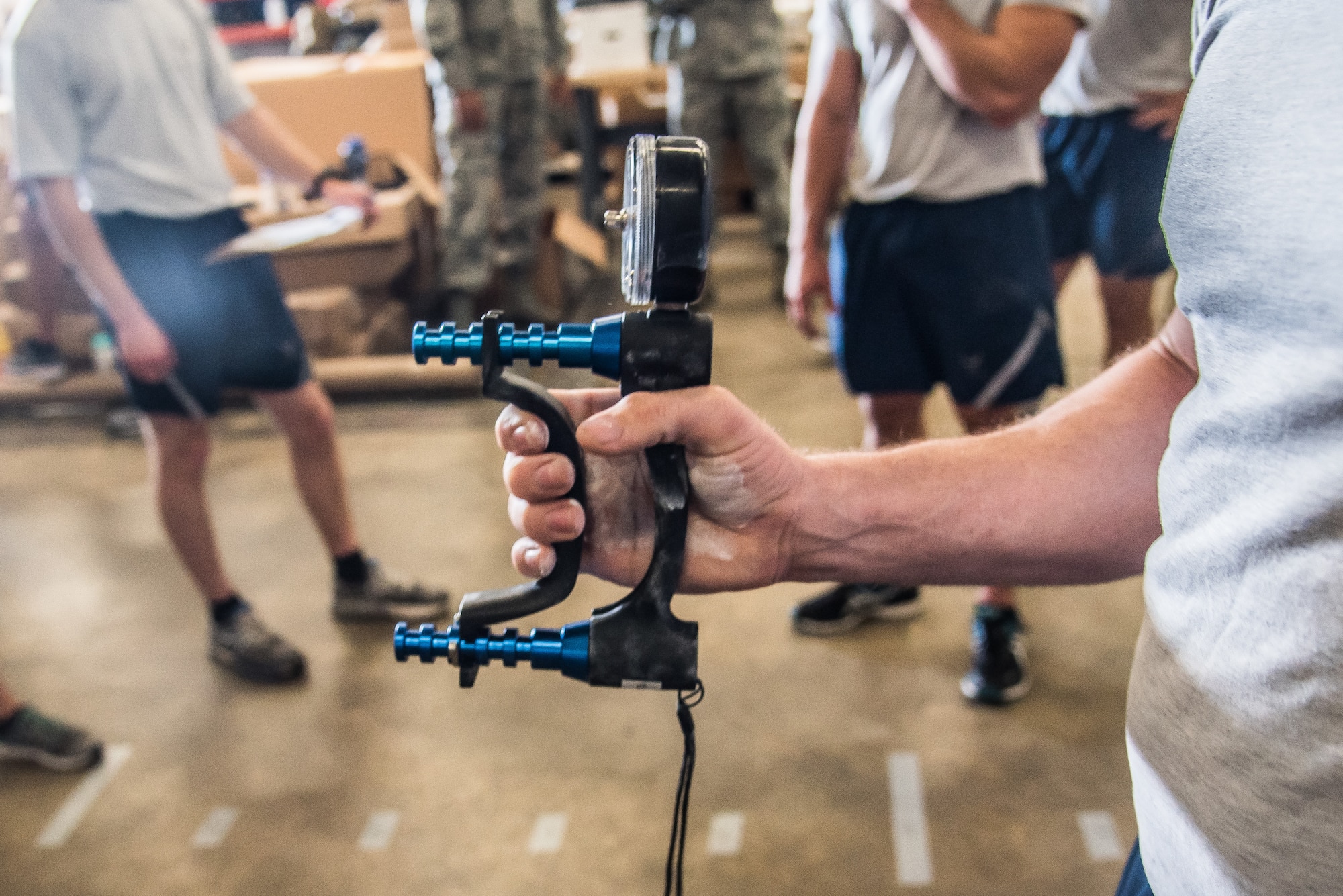 Master Sgt. Garth Muenter, the 512th Explosive Ordnance Disposal manager performs the Grip Strength component during the EOD Tier 2 Physical Fitness Test Prototype at Dover Air Force Base, Del., Aug. 8, 2018. EOD Airmen testing on the Grip Strength component are required to squeeze the dynamometer with maximum strength for two to three seconds. (U.S. Air Force photo by Staff Sgt. Damien Taylor)component are required to squeeze the dynamometer with maximum strength as hard as possible for two or three seconds. (U.S. Air Force photo by Staff Sgt. Damien Taylor)
