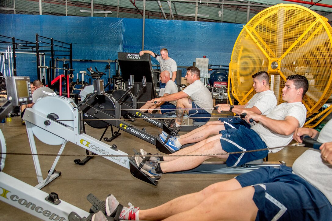 Explosive Ordnance Disposal Airmen perform the Row Ergometer 1,000 meter component of the EOD Tier 2 Physical Fitness Test Prototype at Dover Air Force Base, Del., Aug. 8, 2018. The Row Ergometer 1,000 meter is one of 10 test components administered during the Tier 2 test prototype. (U.S. Air Force photo by Staff Sgt. Damien Taylor)