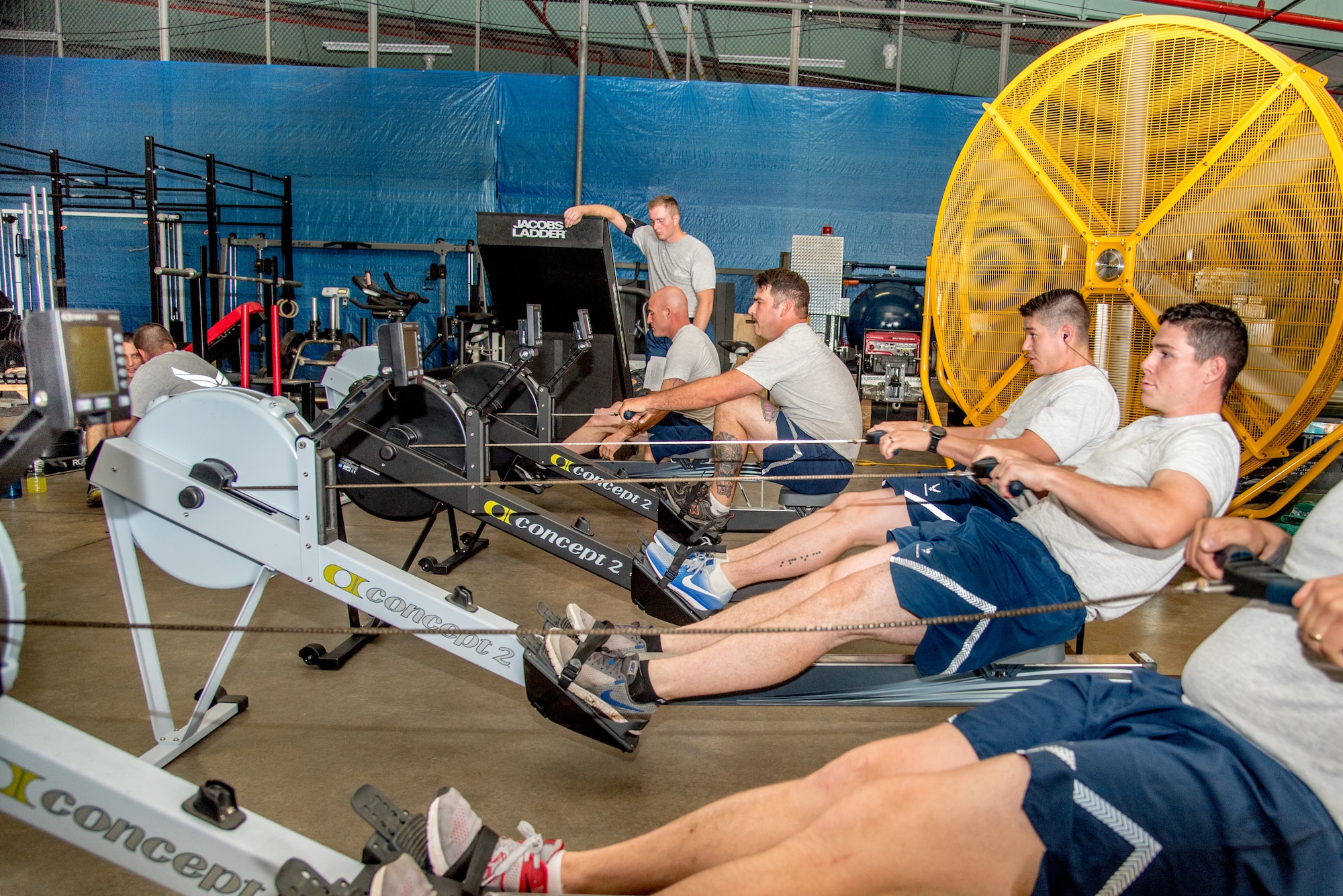 Explosive Ordnance Disposal Airmen perform the Row Ergometer 1,000 meter component of the EOD Tier 2 Physical Fitness Test Prototype at Dover Air Force Base, Del., Aug. 8, 2018. The Row Ergometer 1,000 meter is one of 10 test components administered during the Tier 2 test prototype. (U.S. Air Force photo by Staff Sgt. Damien Taylor)