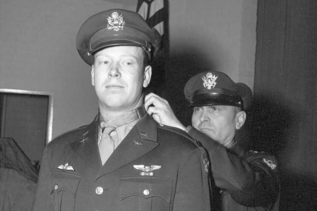 Lt. Gen. Ira Eaker places the Medal of Honor around the neck of World War II Army Air Corps 2nd Lt. John C. Morgan.