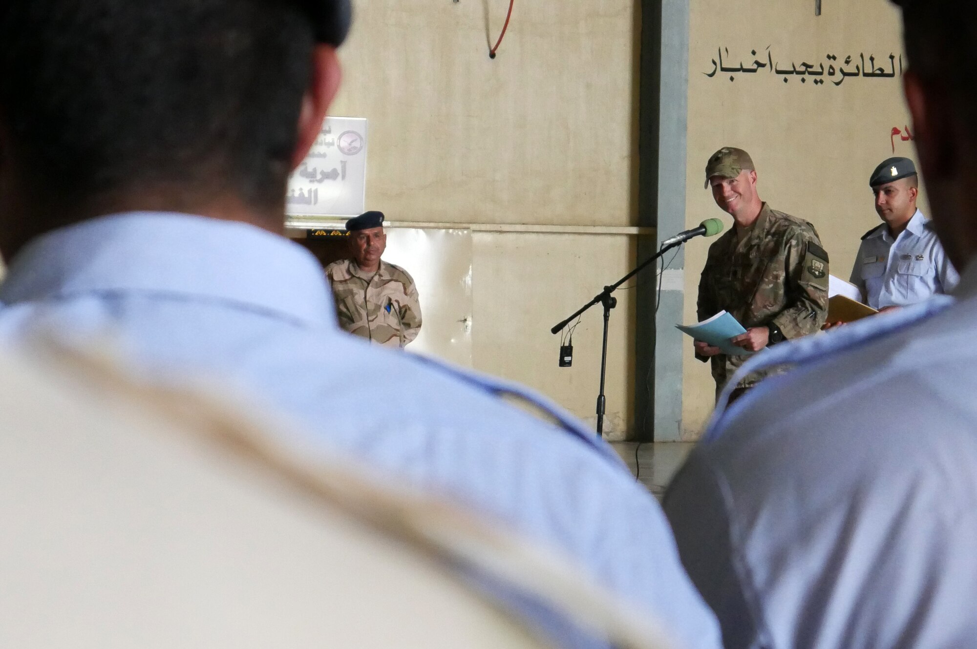 U.S. Air Force Lt. Col. Neal Wilson, 770th Air Expeditionary Advisory Squadron commander, congratulates Iraqi Air Force C-130J Super Hercules maintenance technicians during an upgrade ceremony July 31, 2018, at Al Muthana Air Base, Iraq. U.S. air advisors from the 770th AES continue to provide support and build the partnership capacity with their Iraqi counterparts. (U.S. Air Force photo by Capt. Benjamin Hughes)