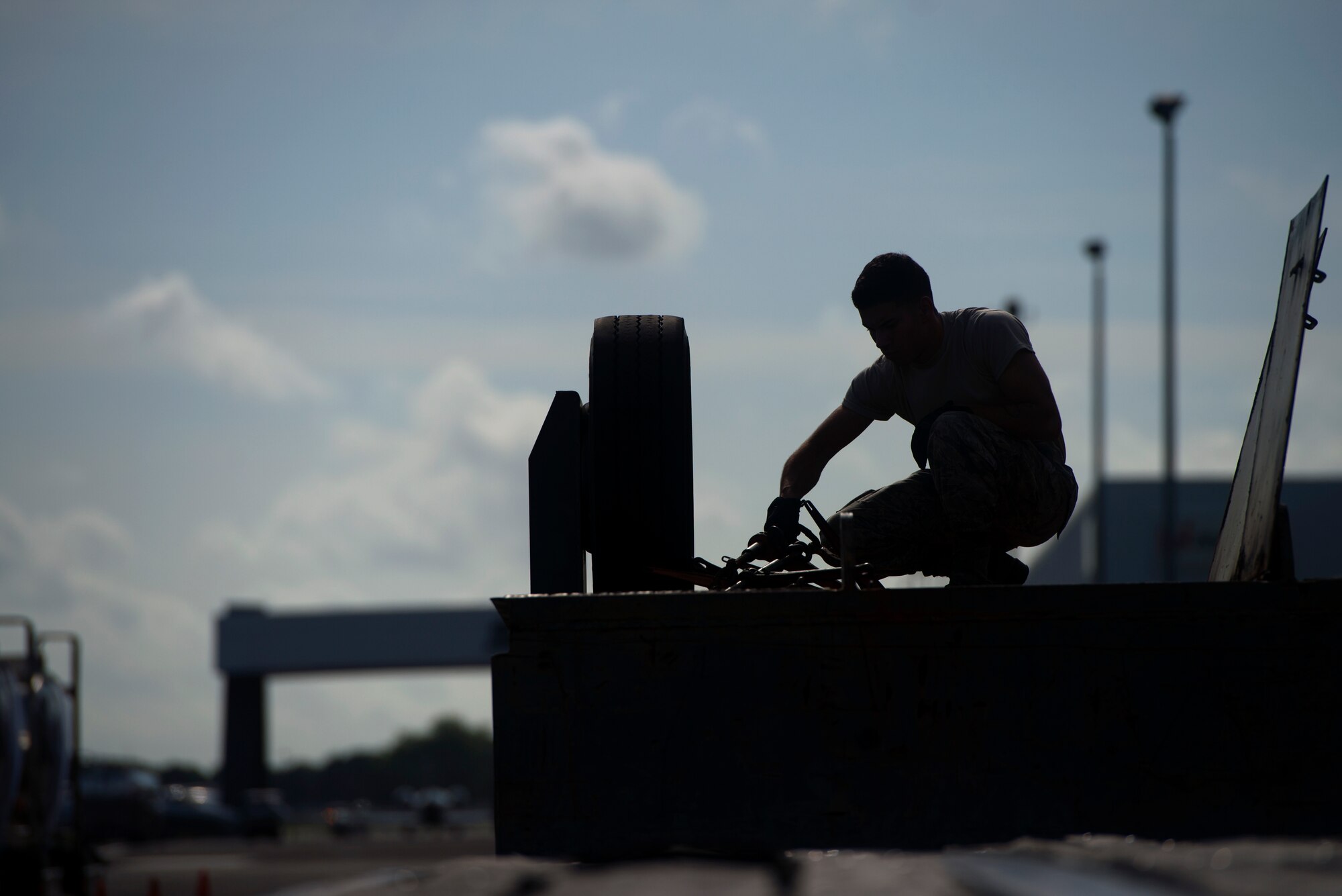 A U.S. Air Force Airman assigned to the 6th Logistics Readiness Squadron loads equipment back onto a trailer after supporting a POTUS mission at Tampa International Airport flightline, July 30, 2018.