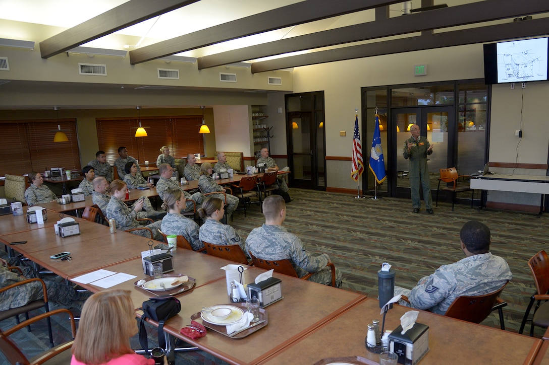 Retired Air Force Maj. Gen. Edward Mechenbier speaks with Reserve Citizen Airmen from the 302nd Airlift Wing, at Peterson Air Force Base, Colorado, Aug. 5, 2018.