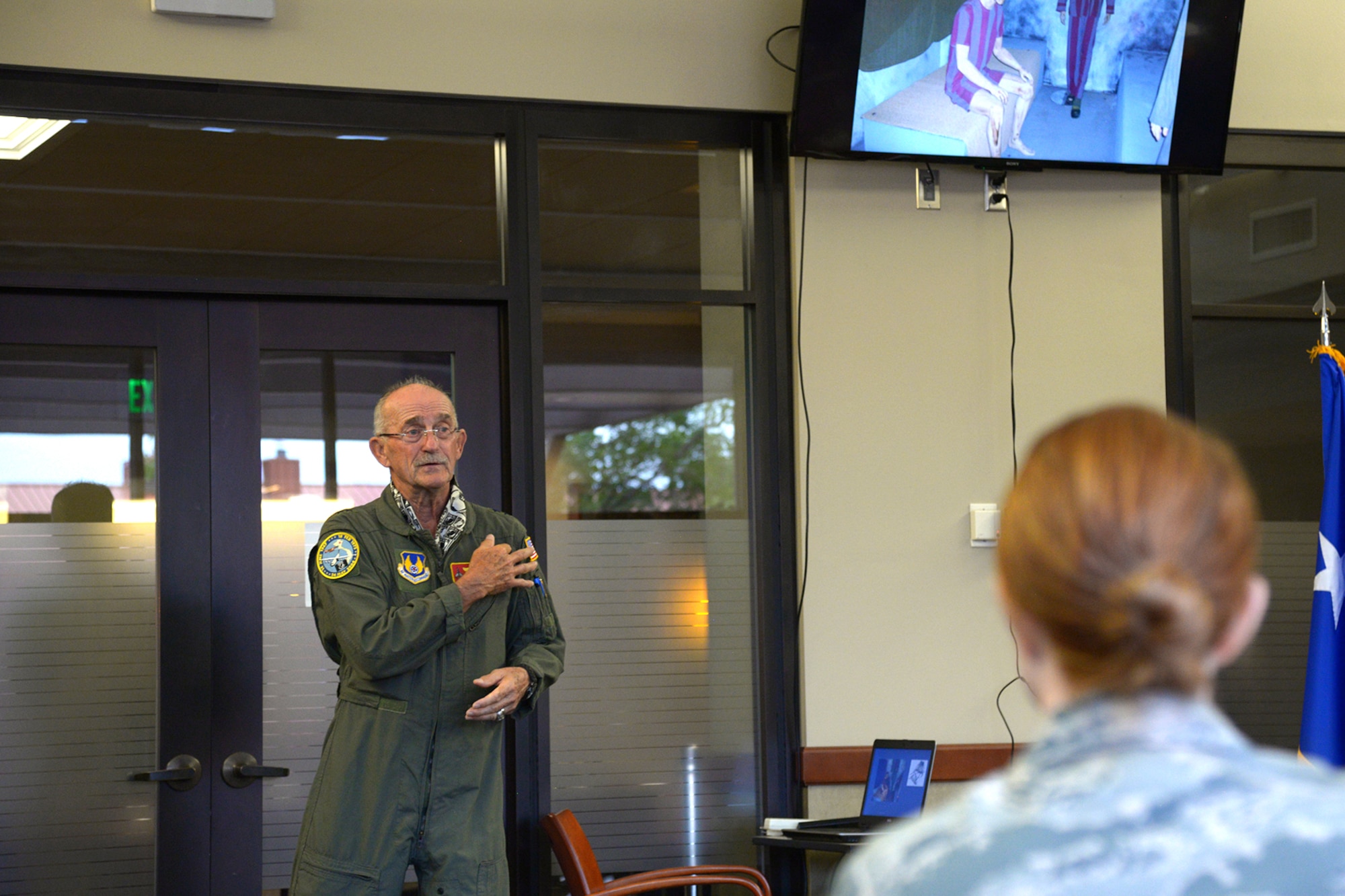 Retired Air Force Maj. Gen. Edward Mechenbier speaks with Reserve Citizen Airmen from the 302nd Airlift Wing, at Peterson Air Force Base, Colorado, Aug. 5, 2018.