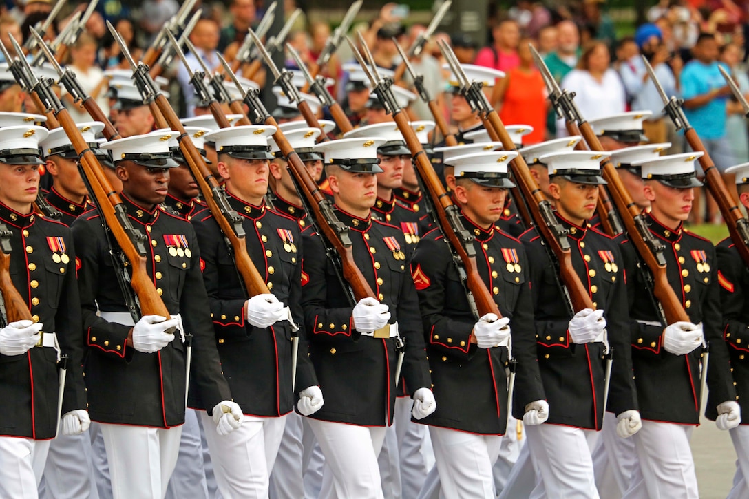 A Marine marching band performs during an evening parade.