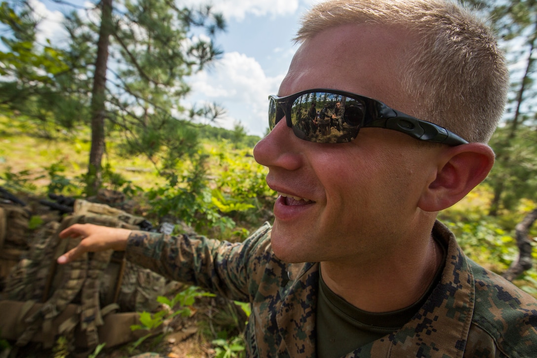 Sgt. Victor Hakes, acting scout sniper platoon sergeant with 3rd Battalion, 25th Marine Regiment, reviews the training day with his Marines during Exercise Northern Strike at Camp Grayling, Mich., Aug. 11, 2018. Exercise Northern Strike is a National Guard Bureau-sponsored training exercise that unites service members from multiple branches, states and coalition countries to conduct combined ground and air combat operations. (U.S. Marine Corps photo by Cpl. Niles Lee)
