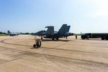 Members of the 375th Operations Support Squadron hot-pit refuel a Navy EA-18G Growler electronic attack aircraft on Scott Air Force Base, Aug. 3, 2018.