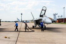 Members of the 375th Operations Support Squadron hot-pit refuel a Navy EA-18G Growler electronic attack aircraft on Scott Air Force Base, Aug. 3, 2018.