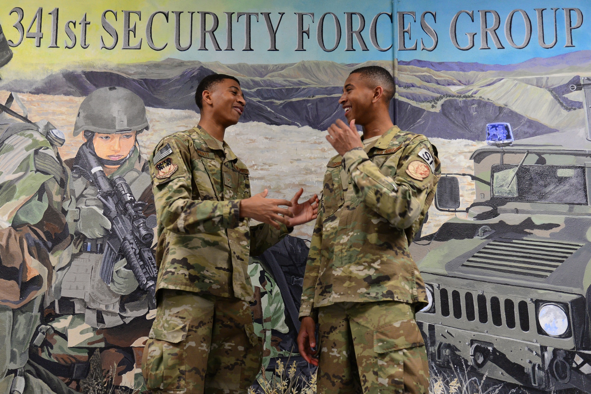 Airman 1st Class Leland, left, and Airman 1st Class Lemuel Spratt, 341st Missile Security Forces Squadron members, share a joke July 19, 2018, at Malmstrom Air Force Base, Mont.