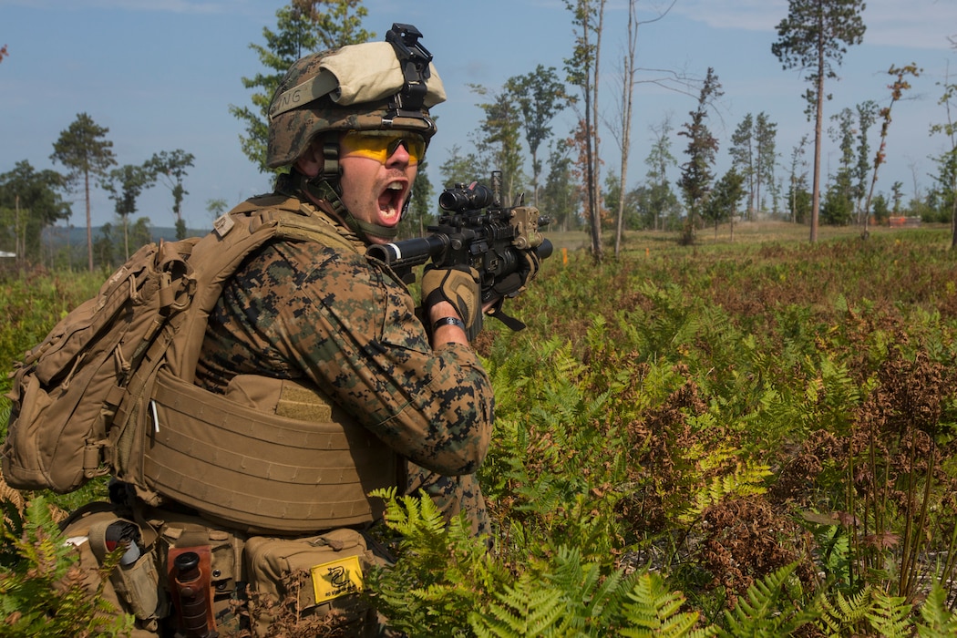 Cpl. Chandler Jones, a team leader with India Company, 3rd Battalion, 25th Marine Regiment, communicates with his Marines during a live-fire range at Camp Grayling, Mich., Aug. 8, 2018. Exercise Northern Strike is a National Guard Bureau-sponsored training exercise that unites service members from multiple branches, states and coalition countries to conduct combined ground and air combat operations. (U.S. Marine Corps photo by Cpl. Niles Lee)