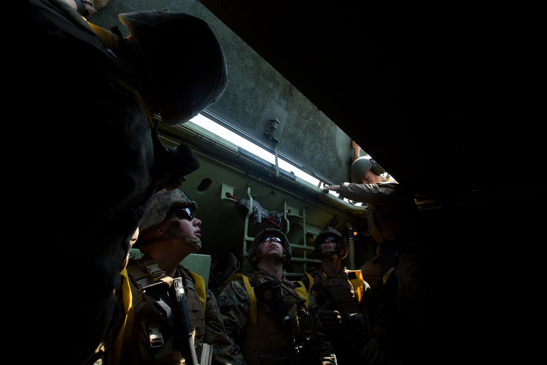 Marines from India Company, 3rd Battalion, 25th Marine Regiment, watch as the crew of an amphibious assault vehicle begin to close all of the hatches of the vehicle to prepare for a lake crossing during Exercise Northern Strike at Camp Grayling, Mich., Aug. 7, 2018. Camp Grayling, the largest National Guard center in the country covering 147,000 acres, offers many large artillery, mortar, tank ranges and maneuver courses. (U.S. Marine Corps photos by Cpl. Niles Lee)