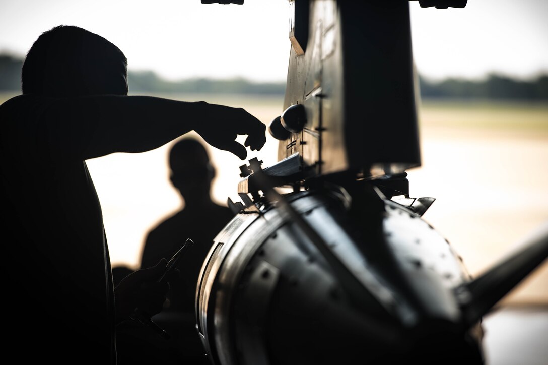 U.S. Air Force Staff Sgt. Samuel Ortiz, 77th Aircraft Maintenance Unit load crew team lead, releases lug nuts on a bomb rack at Shaw Air Force Base, S.C., Aug. 9, 2018.