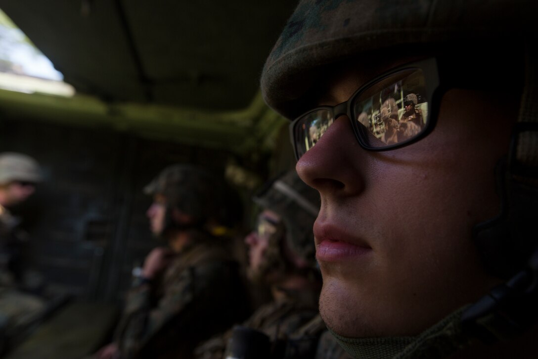 Lance Cpl. Dylan Thornton, a rifleman with India Company, 3rd Battalion, 25th Marine Regiment, sit in the back of an Amphibious Assault Vehicle during Exercise Northern Strike at Camp Grayling, Mich., Aug. 8, 2018. Camp Grayling, the largest National Guard center in the country covering 147,000 acres, offers many large artillery, mortar, tank ranges and maneuver courses. (U.S. Marine Corps photos by Cpl. Niles Lee)