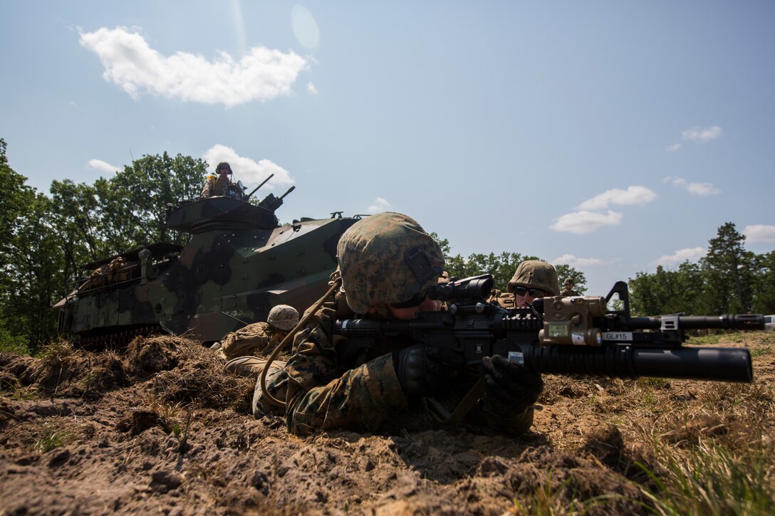 Marines from India Company, 3rd Battalion, 25th Marine Regiment, provide security as the rest of their team exits an Amphibious Assault Vehicle during a live-fire range at Camp Grayling, Mich., Aug. 7, 2018. Camp Grayling, the largest National Guard center in the country covering 147,000 acres, offers many large artillery, mortar, tank ranges and maneuver courses. (U.S. Marine Corps photos by Cpl. Niles Lee)
