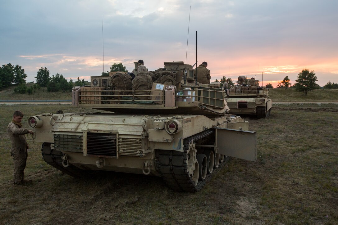 A crew of M1A1 Abrams tank Marines from Alpha Company, 4th Tanks Battlion, prepare for the day’s upcoming range during Exercise Northern Strike at Camp Grayling, Mich., Aug. 9, 2018. Camp Grayling, the largest National Guard center in the country covering 147,000 acres, offers many large artillery, mortar, tank ranges and maneuver courses. (U.S. Marine Corps photos by Cpl. Niles Lee)