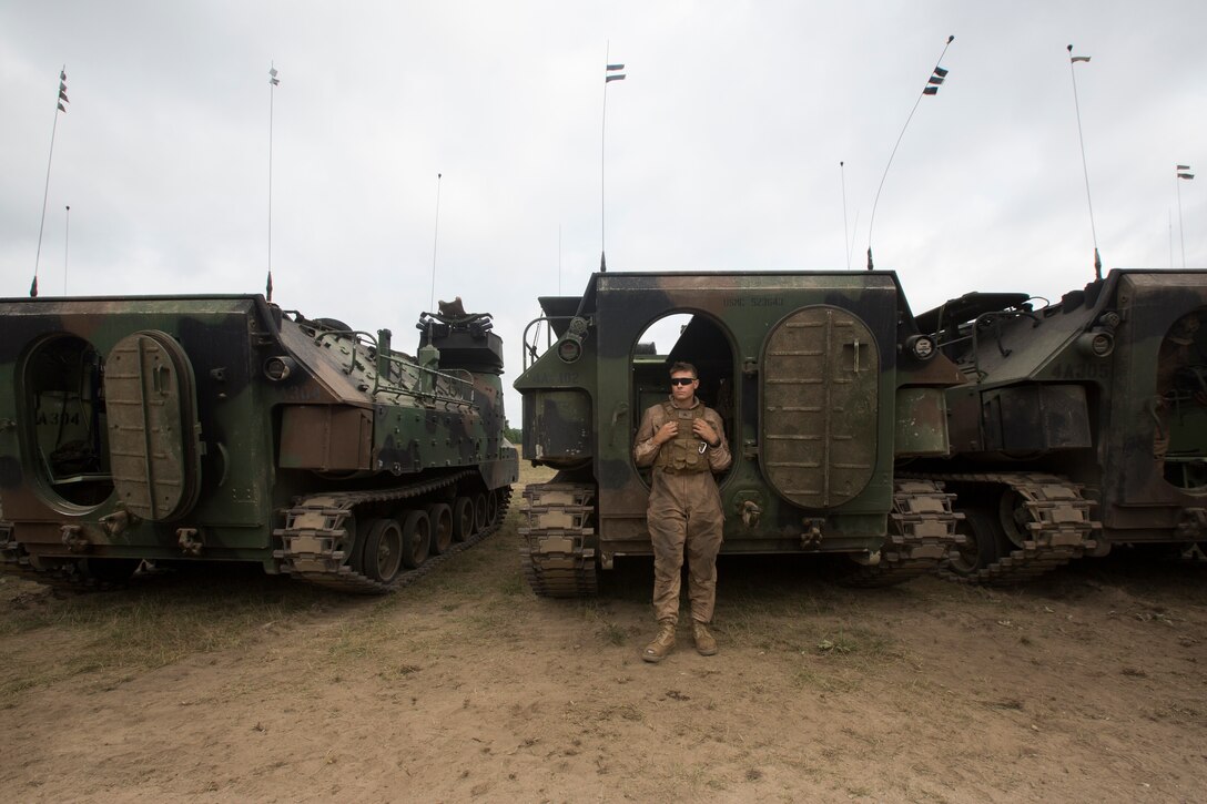 A Marine from Alpha Company, 4th Assault Amphibious Battalion, stands by before a mechanized attack range at Camp Grayling, Mich., Aug. 9, 2018. Camp Grayling, the largest National Guard center in the country covering 147,000 acres, offers many large artillery, mortar, tank ranges and maneuver courses. (U.S. Marine Corps photos by Cpl. Niles Lee)