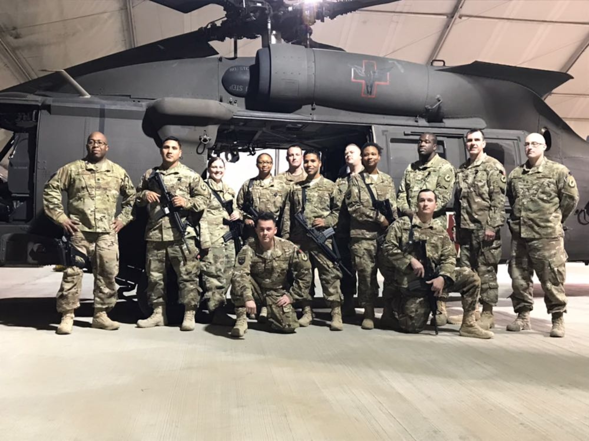 Lt. Col. Patrick Kennedy, 60th Medical Group, poses with members of the Diagnostic and Therapeutic Flight in front a U.S. Army UH-60 Black Hawk medical evacuation helicopter at Bagram Airfield, Afghanistan, during a deployment October 2017 to May 2018.  (Courtesy photo)