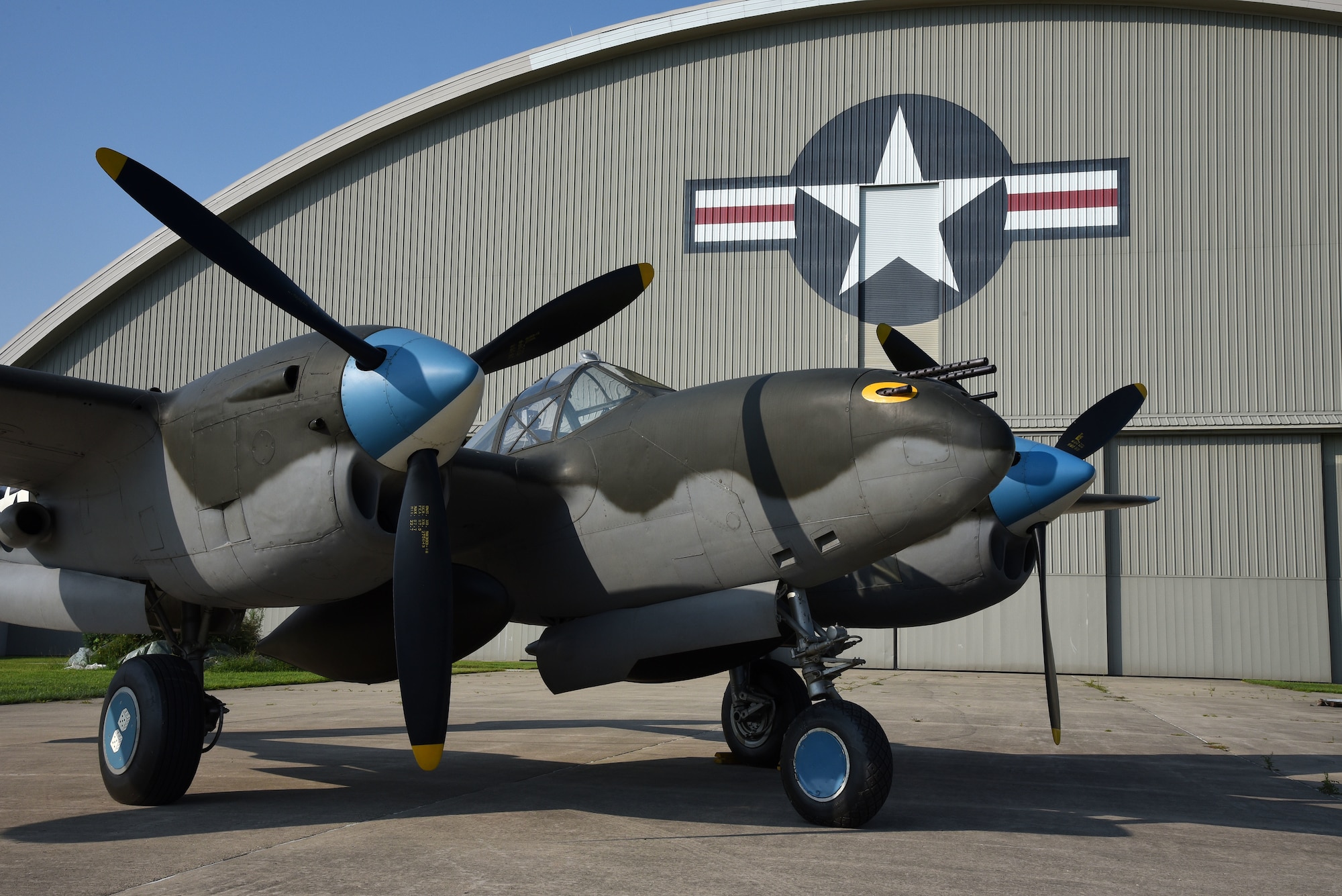 A view of the Lockheed P-38L Lightning before being towed to the WWII Gallery at the National Museum of the U.S. Air Force on Aug. 13, 2018. Several WWII era aircraft on display were temporarily placed throughout the museum to provide adequate space for the Memphis Belle exhibit opening events. (U.S. Air Force photo by Ken LaRock)