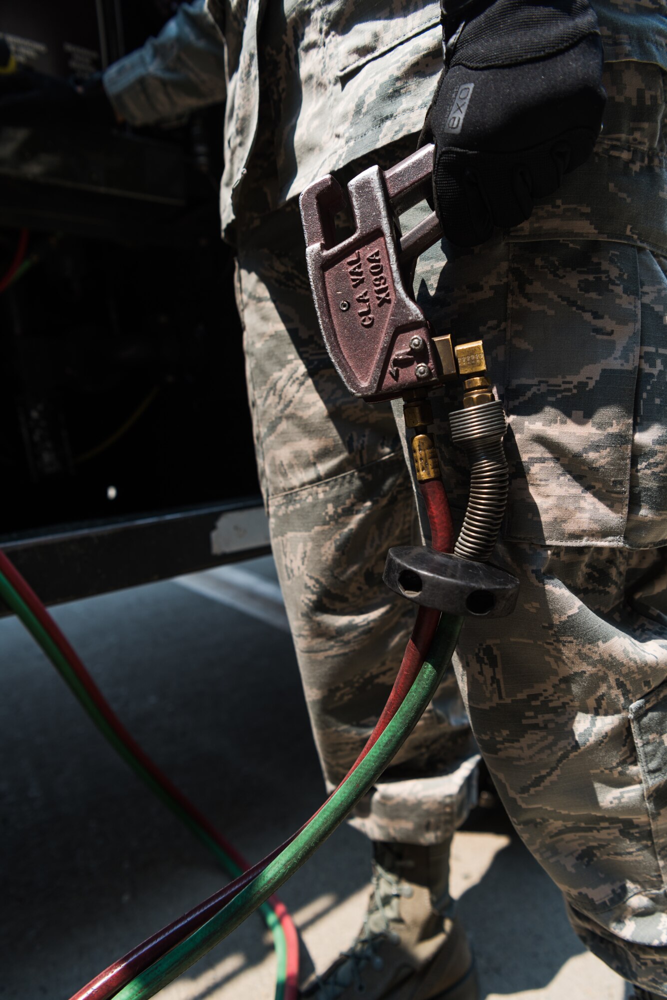 Airman 1st Class Heather Manzanares, 9th Logistics Readiness Squadron petroleum, oil and lubricants operator squeezes a trigger enabling the flow of fuel at Beale Air Force Base, California, Aug. 9, 2018. POL Airmen are responsible for providing fuel to the U-2 Dragon Lady, RQ-4 Global Hawk, T-38 Talon and KC-135 Stratotanker. (U.S. Air Force photo by Senior Airman Justin Parsons)